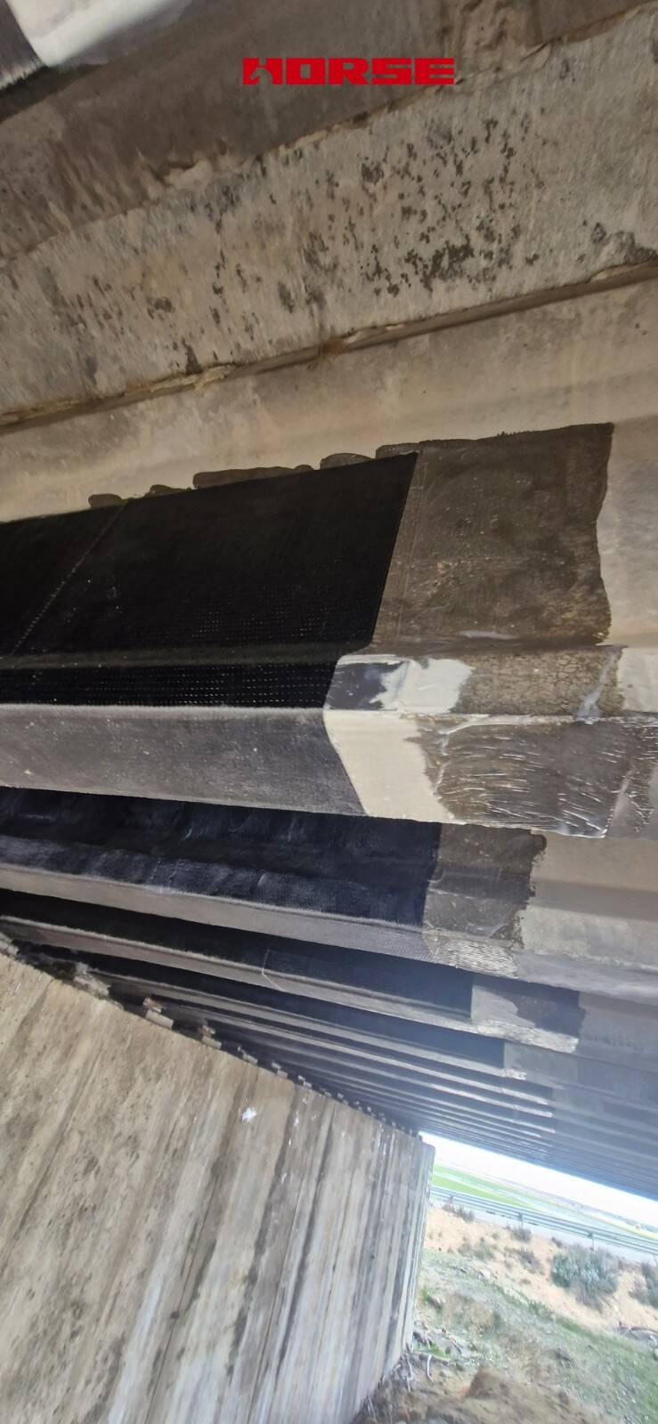 Strengthening of a Prestressed Concrete Multi-Girder Bridge with CFRP Laminate and U-warp