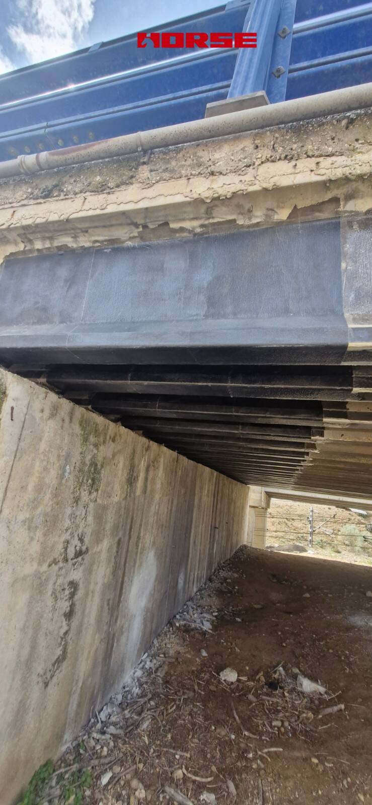 Strengthening of a Prestressed Concrete Multi-Girder Bridge with CFRP Laminate and U-warp