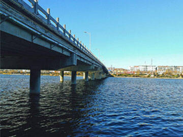 Application of the new reinforcement bridge technology with prestressed CFRP plate